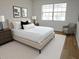 Cozy bedroom featuring a plush bed, neutral tones, and ample natural light at 2297 Lark E Cir # E, Palm Harbor, FL 34684