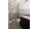 Bathroom featuring a glass enclosed shower with tiled walls and a wooden vanity at 2904 W Marlin Ave, Tampa, FL 33611