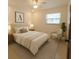 Cozy staged bedroom with natural light, neutral decor, and a comfortable sitting area at 2904 W Marlin Ave, Tampa, FL 33611