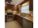 Traditional kitchen with stainless steel appliances and tile backsplash at 2904 W Marlin Ave, Tampa, FL 33611