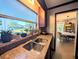 Kitchen with granite countertops, stainless steel sink, and a view into the dining room at 2904 W Marlin Ave, Tampa, FL 33611