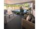 Covered patio with comfortable seating, lush plants, and a view of the backyard at 2904 W Marlin Ave, Tampa, FL 33611
