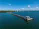 Stunning aerial view of a long pier stretching into the tranquil waters, perfect for leisurely strolls and fishing at 3005 W Helen Ave, Tampa, FL 33611