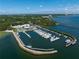An aerial showcases waterfront marina with yachts, a pier, and luxurious amenities, perfect for boating enthusiasts at 3005 W Helen Ave, Tampa, FL 33611