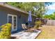 Enjoy outdoor meals on the patio with a table, seating, and grill, with French doors opening to the back yard at 3005 W Helen Ave, Tampa, FL 33611