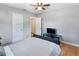 Comfortable bedroom boasts hardwood floors, a ceiling fan, and neutral paint for a peaceful retreat at 3005 W Helen Ave, Tampa, FL 33611