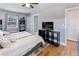 Bright bedroom featuring hardwood floors, neutral paint, and ample storage, offering a comfortable living space at 3005 W Helen Ave, Tampa, FL 33611