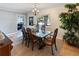 Elegant dining room with hardwood floors, large windows, and decorative light fixture at 3005 W Helen Ave, Tampa, FL 33611
