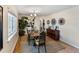 Formal dining room featuring a dining table for six, a sideboard, decorative artwork, and a large window at 3005 W Helen Ave, Tampa, FL 33611