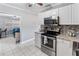 Modern kitchen equipped with stainless steel appliances, white cabinets and granite countertops at 3005 W Helen Ave, Tampa, FL 33611