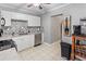 Well-lit kitchen featuring white cabinetry, stainless steel appliances, and stylish backsplash at 3005 W Helen Ave, Tampa, FL 33611