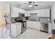 Bright kitchen with white cabinets, stainless steel appliances, and a stylish backsplash at 3005 W Helen Ave, Tampa, FL 33611