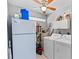 Functional laundry room with appliances, storage, and natural light from glass block window at 3005 W Helen Ave, Tampa, FL 33611