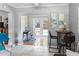 Open floor plan showcasing the sunroom with a desk, seating, and access to backyard at 3005 W Helen Ave, Tampa, FL 33611