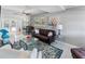 Bright living room with stylish decor, plush seating, and views of the backyard patio from the living room at 3005 W Helen Ave, Tampa, FL 33611