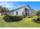 Back exterior showing a screened in porch and manicured lawn at 3023 Bent Creek Dr, Valrico, FL 33596