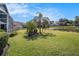 Expansive backyard featuring a serene pond view and lush landscaping, providing a tranquil outdoor space at 3023 Bent Creek Dr, Valrico, FL 33596