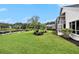 Backyard with lake view, lush landscaping, beautiful palms and a covered lanai at 3023 Bent Creek Dr, Valrico, FL 33596