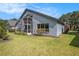 Exterior view of home, featuring backyard, screened in patio, and ample green space at 3023 Bent Creek Dr, Valrico, FL 33596