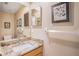 Bathroom vanity with granite countertops, framed mirror, and neutral paint at 3023 Bent Creek Dr, Valrico, FL 33596