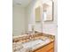 Bathroom vanity with decorative granite countertop, mirror, and white porcelain sink at 3023 Bent Creek Dr, Valrico, FL 33596