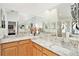 Bathroom featuring dual sinks, granite countertops, ample vanity storage, and a decorative mirror at 3023 Bent Creek Dr, Valrico, FL 33596