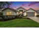 Beautifully landscaped front yard leading to the home's impressive exterior elevation at 3023 Bent Creek Dr, Valrico, FL 33596