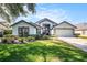 Charming single-Gathering home boasting manicured landscaping and an attached two-car garage for convenience at 3023 Bent Creek Dr, Valrico, FL 33596