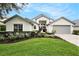 Charming single-story home with a well-manicured lawn and beautifully landscaped flower beds at 3023 Bent Creek Dr, Valrico, FL 33596