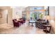 Open-concept living room featuring travertine floors and lots of natural light at 3023 Bent Creek Dr, Valrico, FL 33596