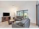 Bright living room with vaulted ceiling, tile floors, large window, neutral tones, and comfortable seating for relaxing at 3023 Bent Creek Dr, Valrico, FL 33596