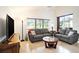 Bright living room with tile floors, neutral tones, and large windows, offering ample natural light and a comfortable seating area at 3023 Bent Creek Dr, Valrico, FL 33596
