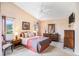 Spacious main bedroom with vaulted ceiling, ceiling fan, carpet, and view to the backyard at 3023 Bent Creek Dr, Valrico, FL 33596