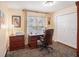 Comfortable office with wood desk, patterned rug, and natural light from the window at 3023 Bent Creek Dr, Valrico, FL 33596