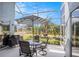 Relaxing screened patio with dining set and beautiful views of the lake at 3023 Bent Creek Dr, Valrico, FL 33596