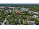 Aerial view of the community including a pond surrounded by lush green trees at 3078 Pointer Dr, Palm Harbor, FL 34683