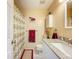 This bathroom has a combination shower and tub, with tile floors and granite countertops at 3078 Pointer Dr, Palm Harbor, FL 34683