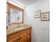 Bathroom vanity with granite countertop, mosaic tile backsplash, and framed mirror at 3078 Pointer Dr, Palm Harbor, FL 34683