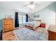 This bedroom features hardwood floors, with natural light from the window, and a ceiling fan at 3078 Pointer Dr, Palm Harbor, FL 34683