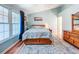 This bedroom features hardwood floors, with natural light from the window, and a ceiling fan at 3078 Pointer Dr, Palm Harbor, FL 34683