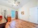 This bedroom has hardwood floors and a ceiling fan, as well as natural light from the window at 3078 Pointer Dr, Palm Harbor, FL 34683