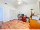 This bedroom has a closet and hardwood floors, as well as a ceiling fan at 3078 Pointer Dr, Palm Harbor, FL 34683