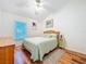 Bedroom with wood flooring, ceiling fan, and natural light from the window at 3078 Pointer Dr, Palm Harbor, FL 34683