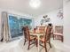 Dining room features a wood table, chairs, and sliding doors to the outdoor patio at 3078 Pointer Dr, Palm Harbor, FL 34683