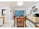 Dining area with tile floors, dining table, and a view of the screened-in lanai at 3078 Pointer Dr, Palm Harbor, FL 34683
