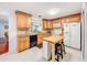 Kitchen features wooden cabinets, granite countertops, tile backsplash, and a center island at 3078 Pointer Dr, Palm Harbor, FL 34683