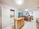 Kitchen area with adjacent washer/dryer, center island, and dining area at 3078 Pointer Dr, Palm Harbor, FL 34683