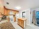 Kitchen area with granite countertops, island, stainless appliances, and washer/dryer at 3078 Pointer Dr, Palm Harbor, FL 34683