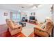 Bright living room with hardwood floors, ceiling fan, and neutral decor at 3078 Pointer Dr, Palm Harbor, FL 34683