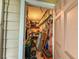 Compact storage room with shelving and pegboards for organizing tools at 3078 Pointer Dr, Palm Harbor, FL 34683